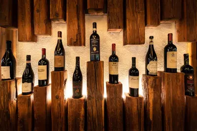 a bunch of bottles of wine are lined up against a wall at Hotel Stella in Moena