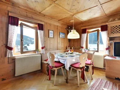 a kitchen and dining room with a white table and chairs at Apartment Luca by Interhome in Ortisei