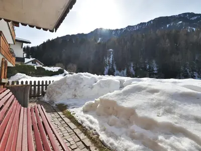 two chairs and an umbrella in the yard of a house at Apartment Demetz by Interhome in Ortisei