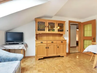 a living room with a tv and a wooden cabinet at Apartment Demetz by Interhome in Ortisei