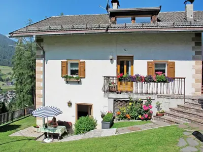 a white house with a fence in the snow at Apartment Mastle by Interhome in Ortisei