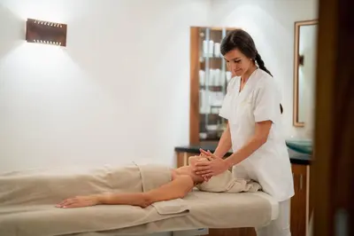a woman in a hospital room treating a patient at Renè Dolomites Boutique Hotel in Pozza di Fassa