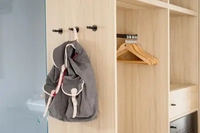 a bag hanging on a door in a kitchen at Hotel Schwarzschmied, a Member of Design Hotels in Lana