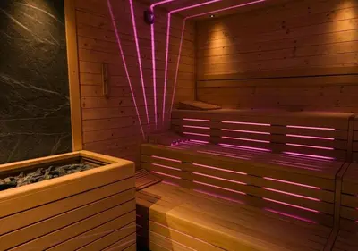 a bedroom with a bed and a chair in a attic at Hotel Resort Veronza in Cavalese