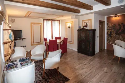 a billiard room with two pool tables and chairs at Hotel Resort Al Sole in Canazei