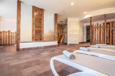 a room with a row of sinks and mirrors at Sporting Clubresidence in San Martino di Castrozza
