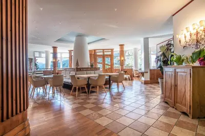 a dining room with a table and chairs at Sporting Clubresidence in San Martino di Castrozza