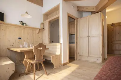 a room with a wooden desk and a chair at Sporting Clubresidence in San Martino di Castrozza
