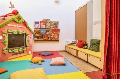 a room with a play room with a play house at Sporting Clubresidence in San Martino di Castrozza
