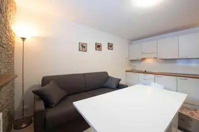 a living room with a couch and a table at Casa Penia 2 in Canazei