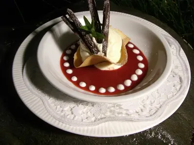 a white plate with a dessert on a table at Hotel Braunsbergerhof in Lana