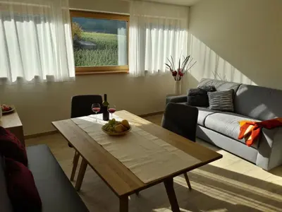 a living room with a table and a couch at Versigglhof in Appiano sulla Strada del Vino