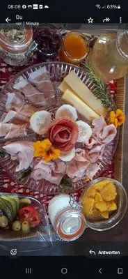 a tray filled with meats and cheese and other foods at Versigglhof in Appiano sulla Strada del Vino