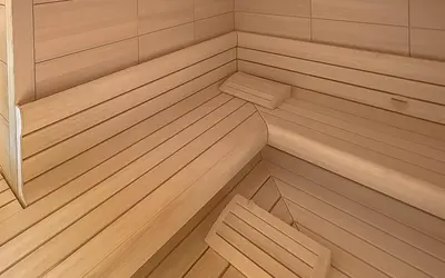 a small sauna with wood paneling and wooden floors at Hotel ADLER Carezza in Nova Levante