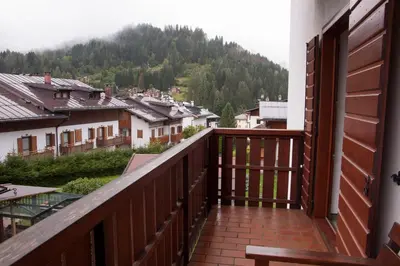 a balcony with a view of a town at Garnì Mariolina in Falcade