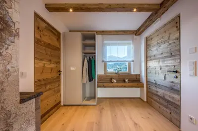 a bathroom with wooden walls and a sliding door at Appartment Hossler in Valdaora