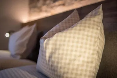 a couple of pillows sitting on a bed at Appartment Hossler in Valdaora