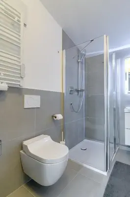 a bathroom with a toilet and a shower at Sonnenuhr Bolzano Apartments in Bolzano
