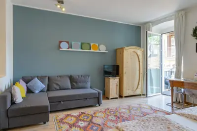 a living room with a couch and a table at Sonnenuhr Bolzano Apartments in Bolzano