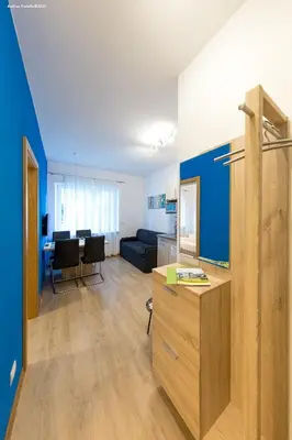 a living room with a couch and a table at City Charme Apartments in Bolzano