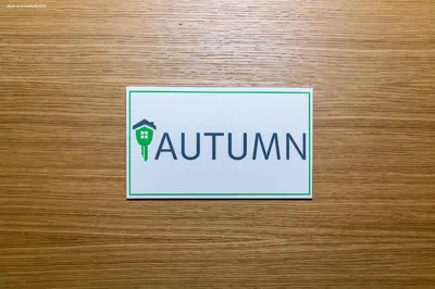 a sign on a wooden door with the word kautum at City Charme Apartments in Bolzano