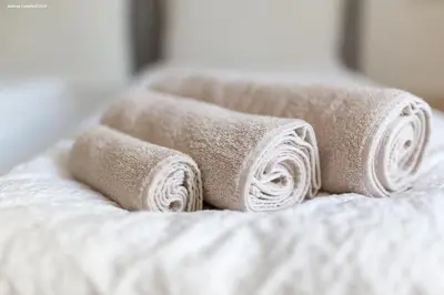 a group of rolled towels on a bed at City Charme Apartments in Bolzano