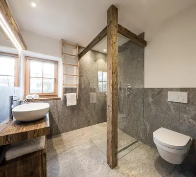 a bathroom with a sink and a toilet and a shower at Kräutererbe Bacherhof in Nalles