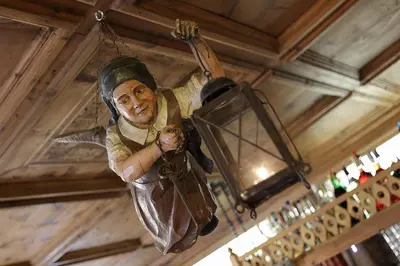 a statue of a man hanging from a ceiling at Historic Hotel Ristorante La Stua in Cavalese