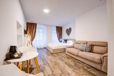 a living room with a couch and a bed at Taste Living in Merano