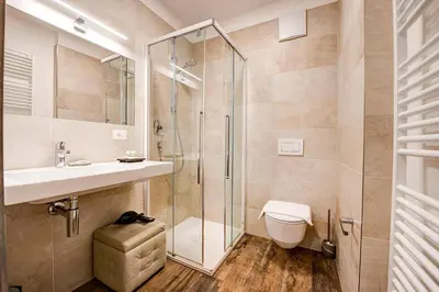 a bathroom with a shower and a sink and a toilet at Taste Living in Merano
