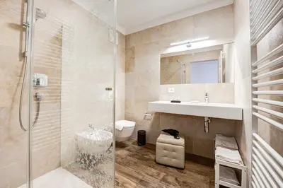a bathroom with a shower and a sink and a toilet at Taste Living in Merano