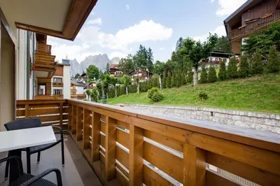a balcony with a view of a mountain at Radisson Residences Savoia Palace Cortina d’Ampezzo in Cortina dʼAmpezzo