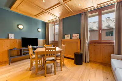 a dining room with a table and chairs at Radisson Residences Savoia Palace Cortina d’Ampezzo in Cortina dʼAmpezzo
