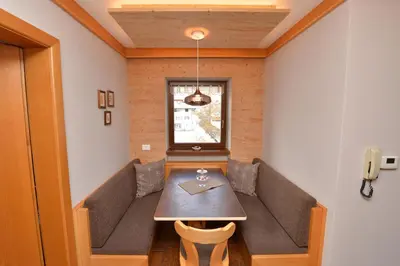 a dining room with a couch and a table at Apartment Nogler Frieda in Selva di Val Gardena