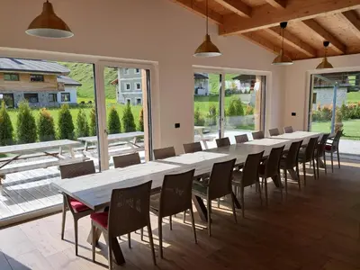 a large conference room with a long table and chairs at Chalet Dumbria Dolomites in Selva di Val Gardena
