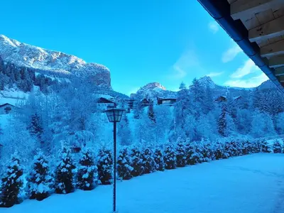 a light pole in the snow with mountains in the background at Chalet Dumbria Dolomites in Selva di Val Gardena