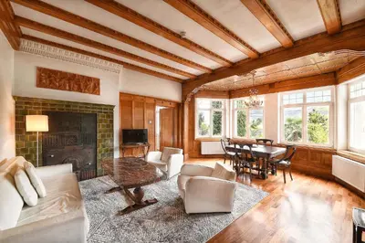 a living room with a table and a fireplace at Villa Verdi Apartments in Merano