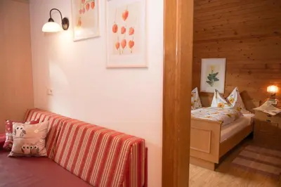 a room with a bed and a couch in it at Appartements Hoferhof in Villabassa