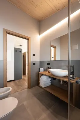 a bathroom with a sink and a mirror at Garnì La Violetta in Soraga
