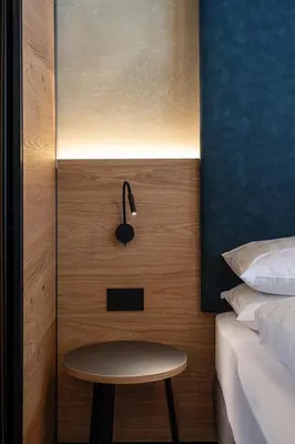 a bedroom with a table next to a bed at Garnì La Violetta in Soraga