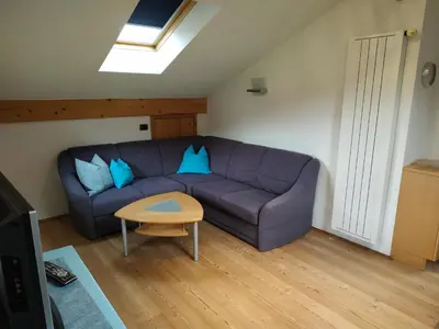 a living room with a purple couch and a table at Apartments Blumenheim in Castelrotto