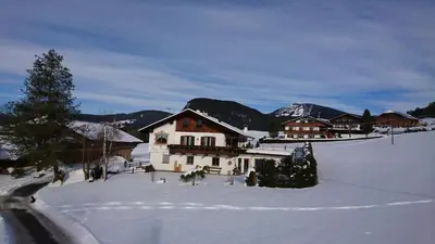 a house in the snow with a snow covered yard at Apartments Blumenheim in Castelrotto