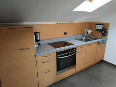 a kitchen with a sink and a stove at Apartments Blumenheim in Castelrotto