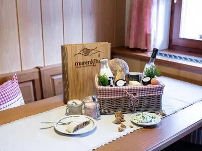 a basket of wine and food on a table at Marenklhof in Tesido