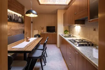 a kitchen with a wooden table and a stove at Marenklhof in Tesido