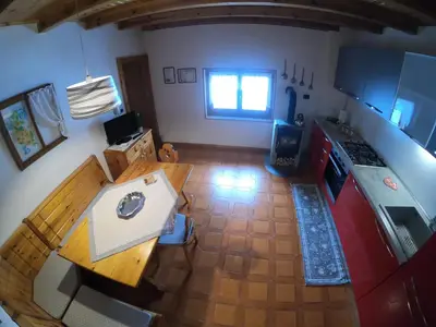 an overhead view of a kitchen with a wooden table at Casa Aurora -Altopiano di Pinè in Bedollo