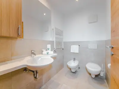 a bathroom with a sink and a toilet at Residence Brunello in Ortisei