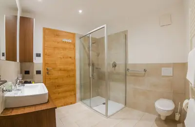 a bathroom with a shower and a sink and a toilet at Residence Brunello in Ortisei