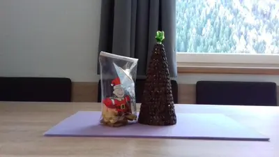 a small christmas tree and a santa figurine on a table at Residence Brunello in Ortisei