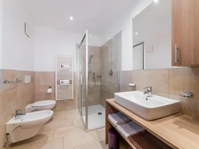 a bathroom with a sink and a toilet and a shower at Residence Brunello in Ortisei